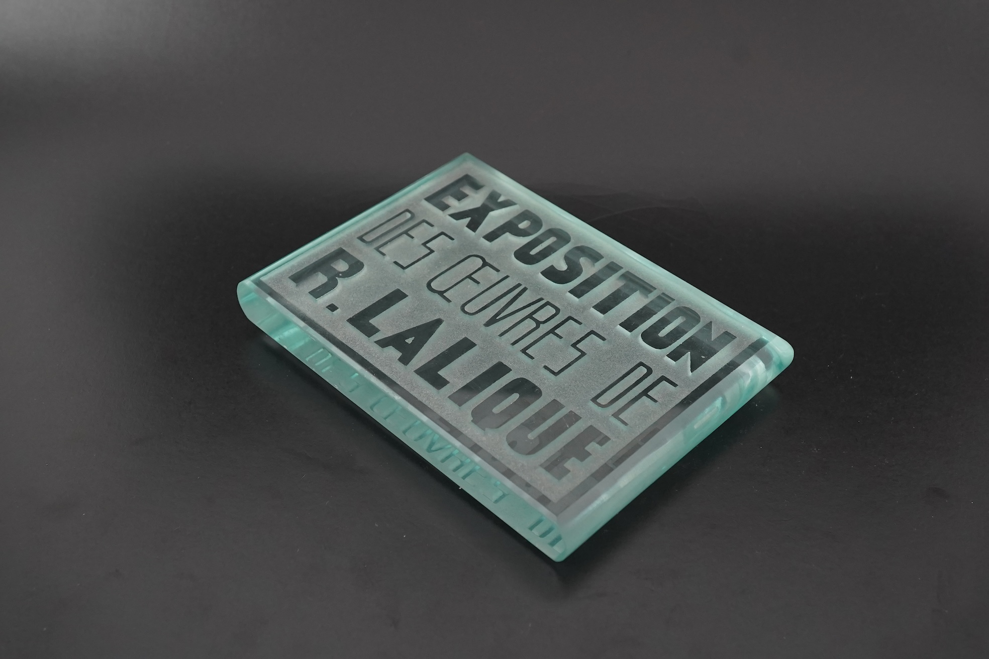 Lalique: A glass advertising plaque 'EXPOSITION DES ŒUVRES DE R.LALIQUE'